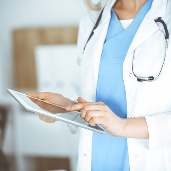 healthcare professional using a tablet